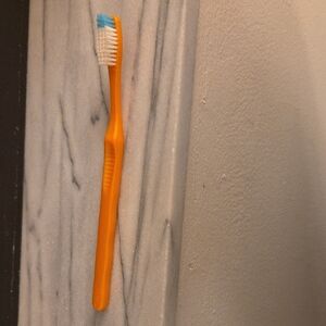 Orange Toothbrush with Blue and White Bristles